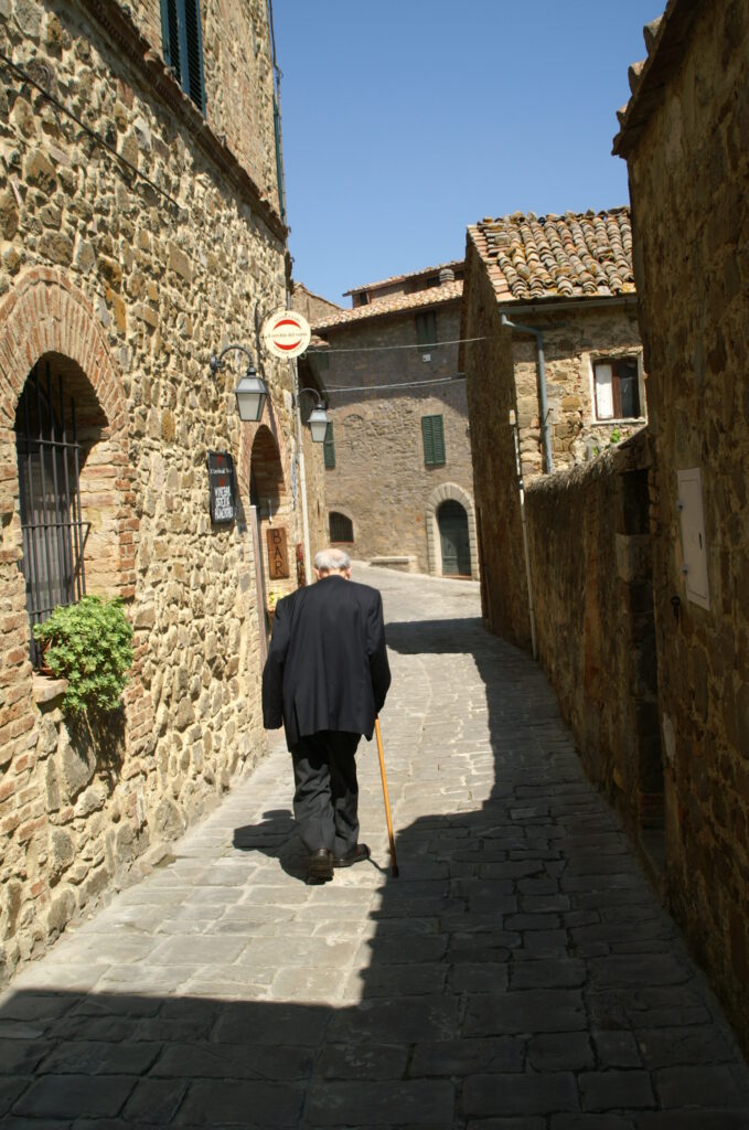 Don Brandi di spalle in un vicolo di Sant'Angelo in Colle